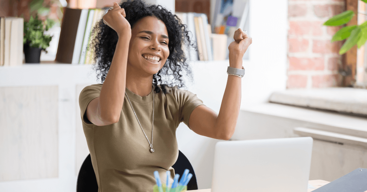 Woman celebrating at her laptop